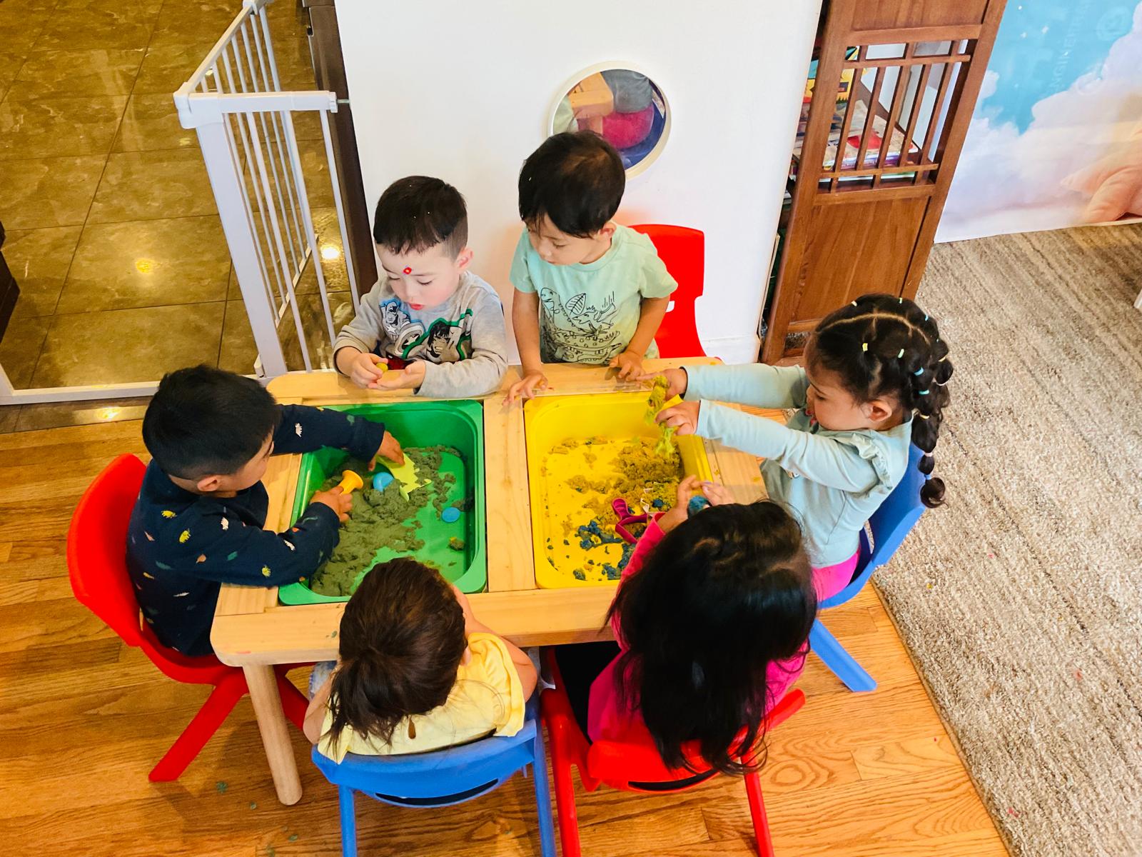 Children exploring sensory play together in the classroom