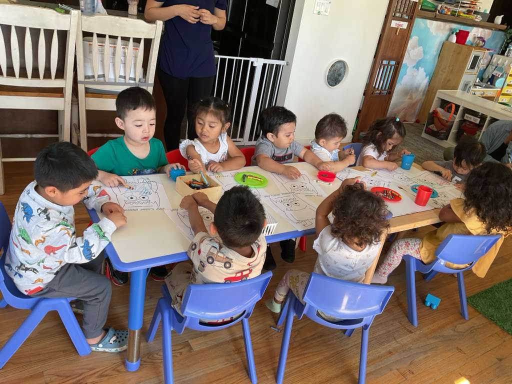 Children enjoying learning activities together at Amiguitos Daycare